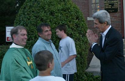 Democratic presidential candidate Sen. John Kerry (news - web sites), D-Mass., right, greets Father Cannon, left, Francis Flaherty, second from left, and Flaherty's son Anthony, 12, foreground, after attending mass at Chapel of Our Lady of Good Voyage in Boston, on Sunday, June 27, 2004. Kerry canceled plans to address the 72nd Annual Meeting of the U.S. Conference of Mayors on Monday which is likely to be picketed by police officers. (AP Photo/Jeff Chiu)